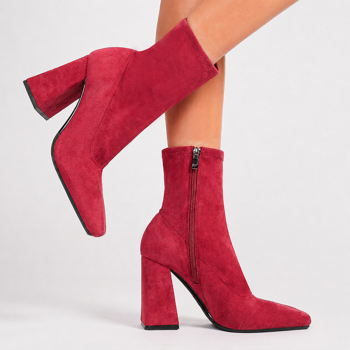 Moncelia red suede square toe flared heel booties, side view on model mid-step, women's sizes 5 to 11.5