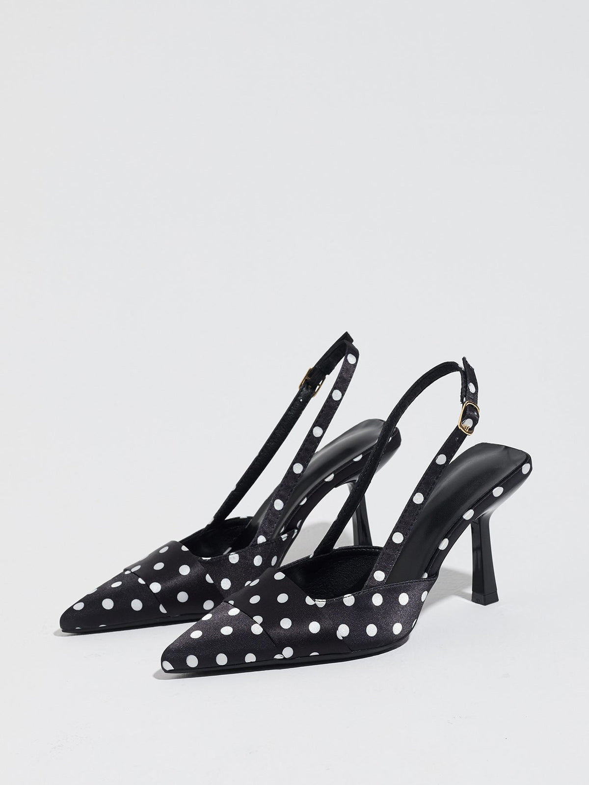 Moncelia black polka dot satin slingbacks, pair shown from the side with white dots, women's sizes 5 to 12