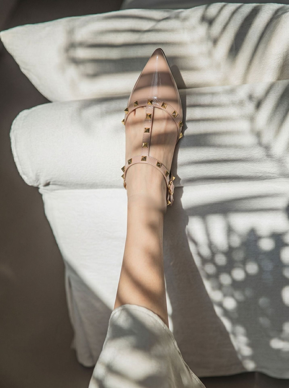 Moncelia beige studded T-strap flats, close-up of studded strap on the foot, women's sizes 5 to 10.5