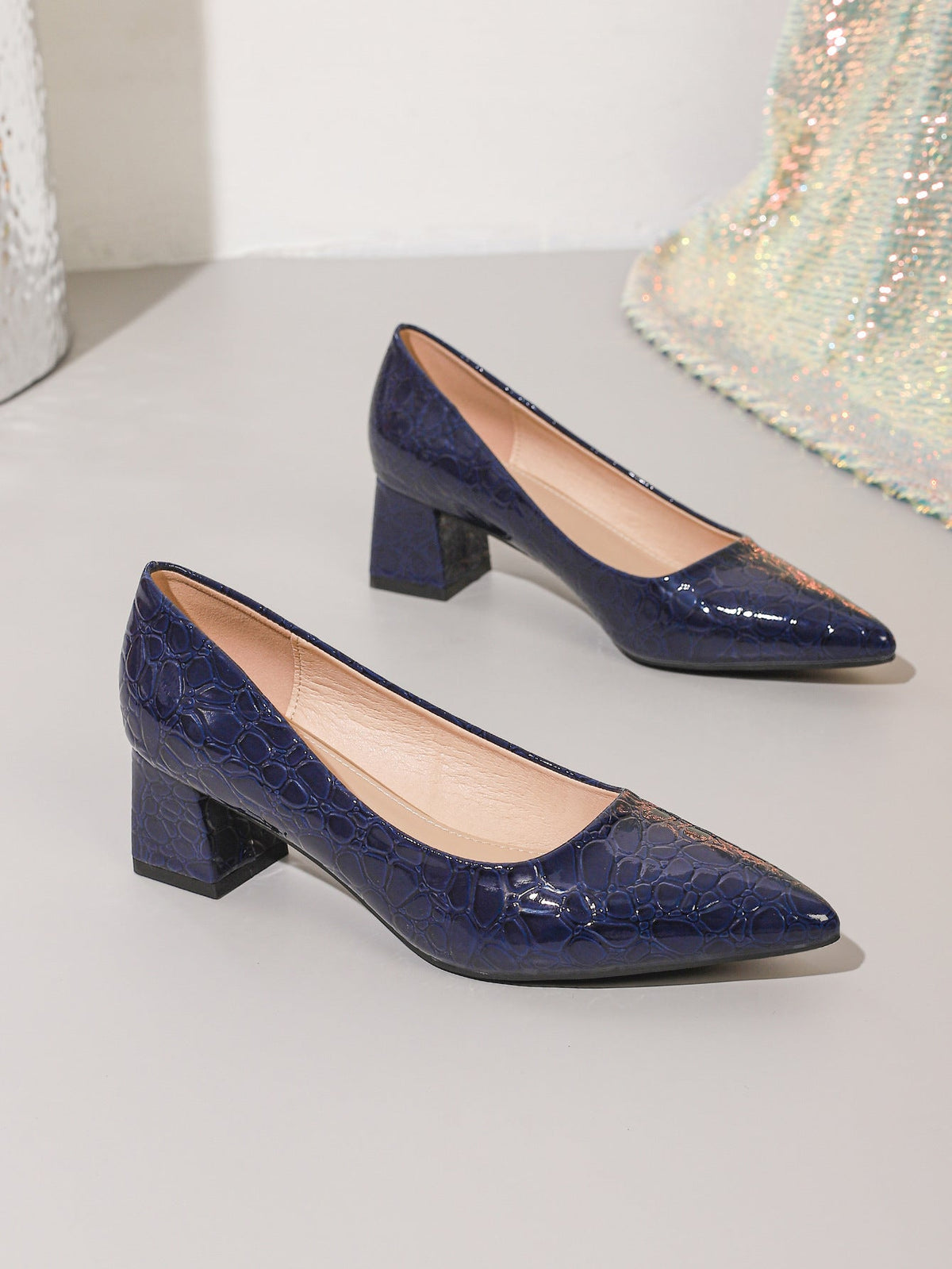 Moncelia navy croc-embossed block heel pumps, pair shown from the side, women's sizes 5.5 to 12