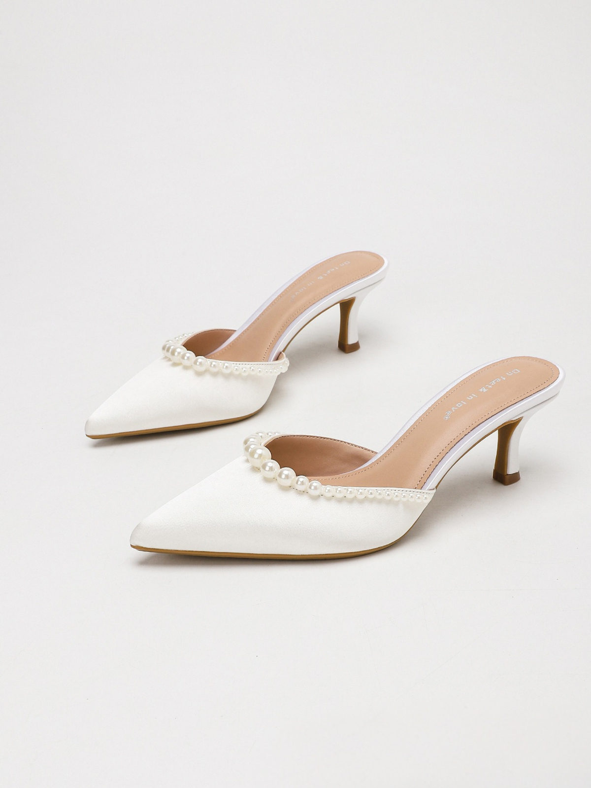 Moncelia ivory pearl trim satin mules, pair shown from the side, women's sizes 5 to 11.5