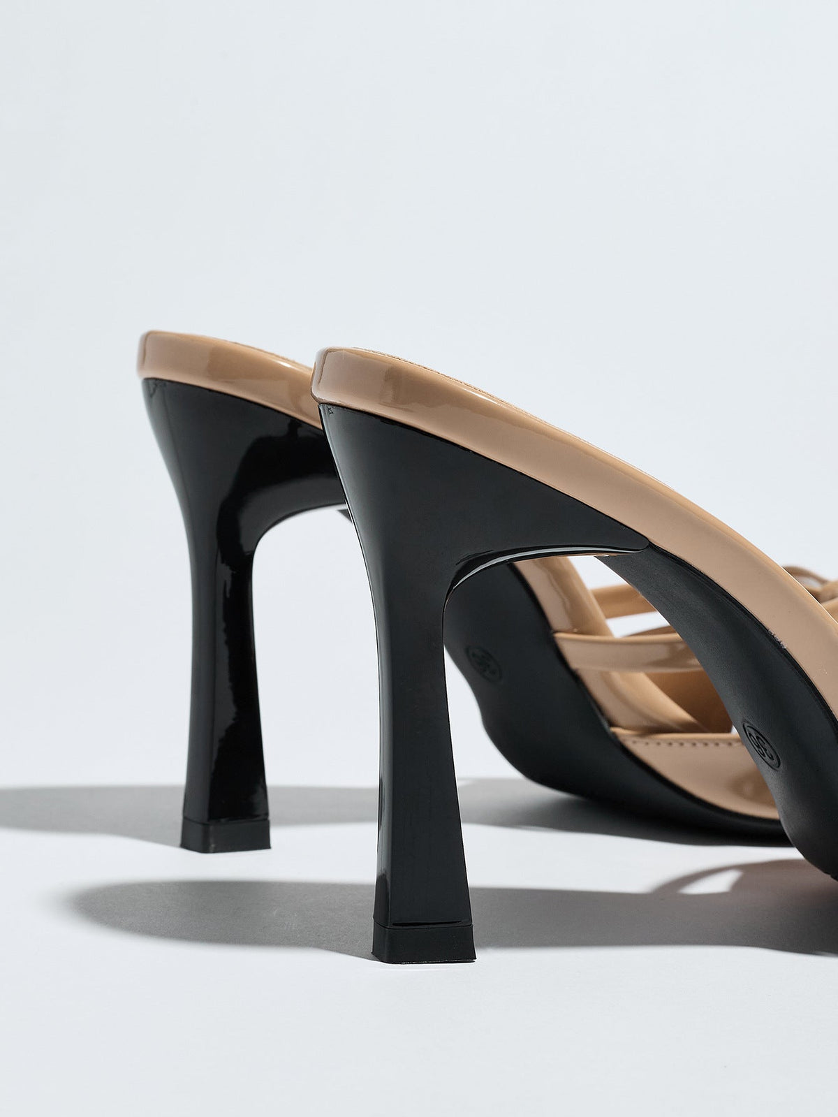 Moncelia apricot bow pointed toe heeled mules, back view showing flared black heels, women's sizes 5 to 12