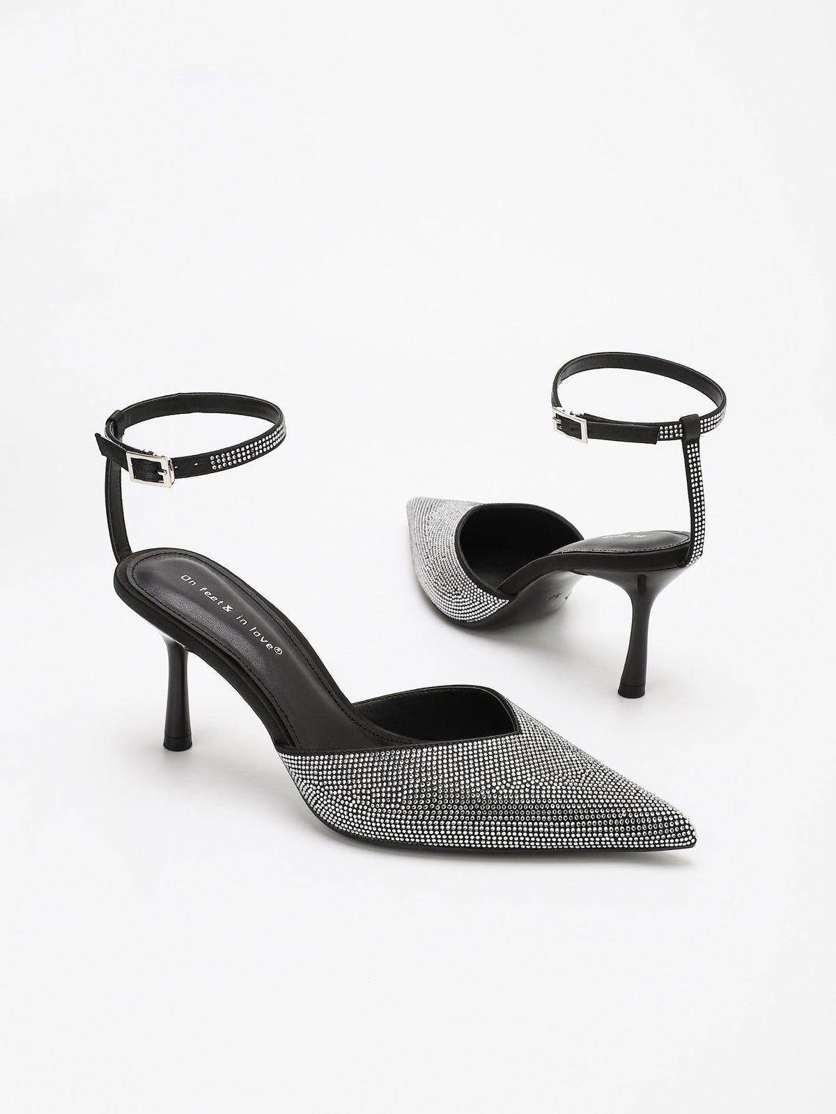 Moncelia black crystal paved pointed toe mules, pair shown from the side, women's sizes 5 to 11.5