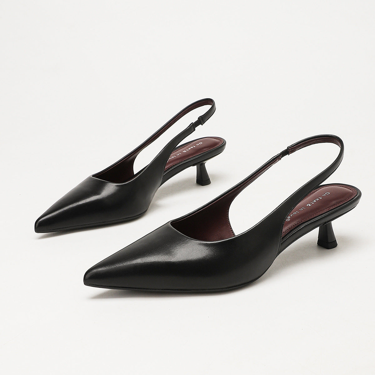 Moncelia black pointed toe slingback spool heels, pair shown from the side, women's sizes 5 to 11.5