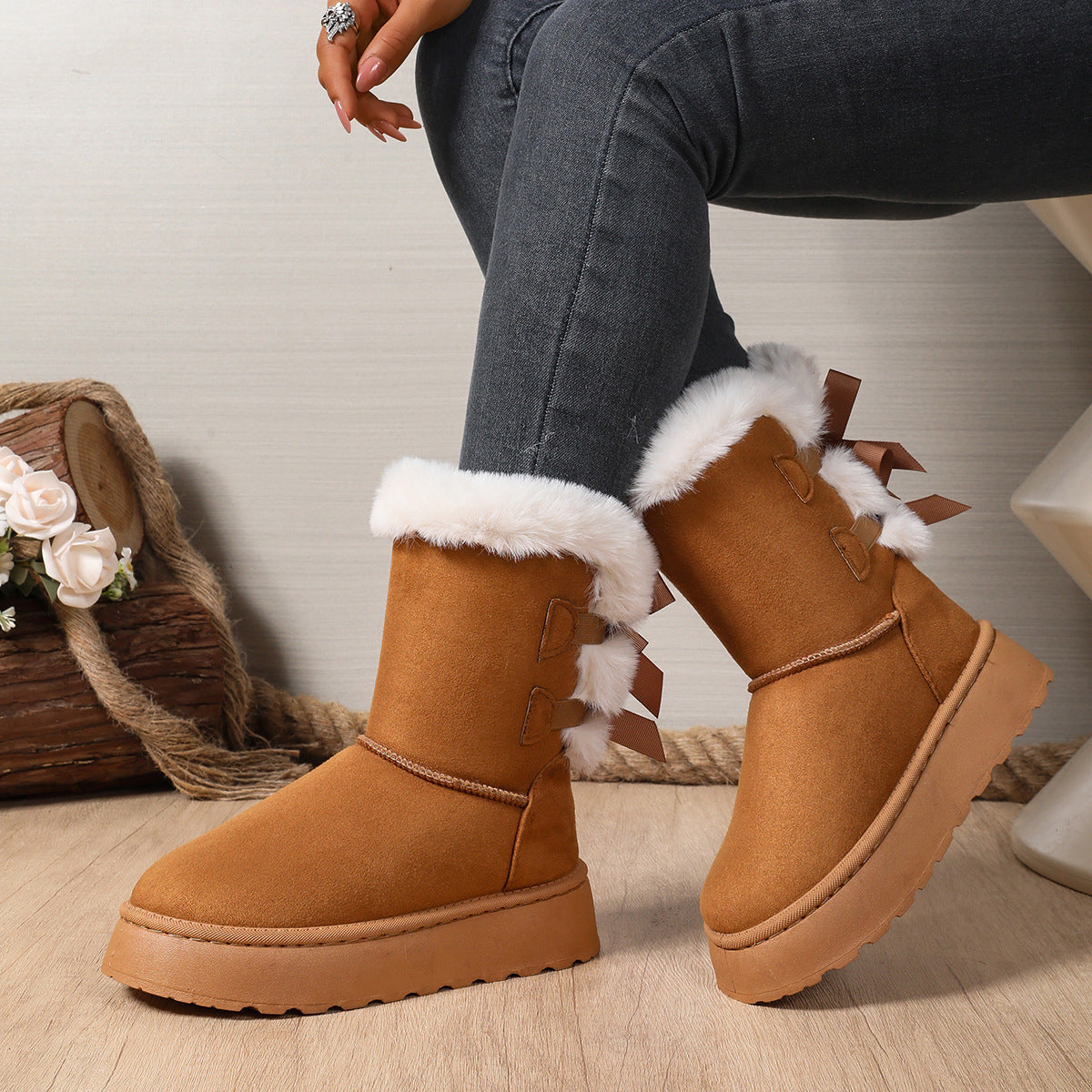Margo & Main – Delia brown bow-back plush cuff snow boots on model, seated view, US women's sizes