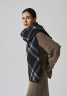 Margo & Main black check scarf — side view wrapped over a camel knit, long ends draped