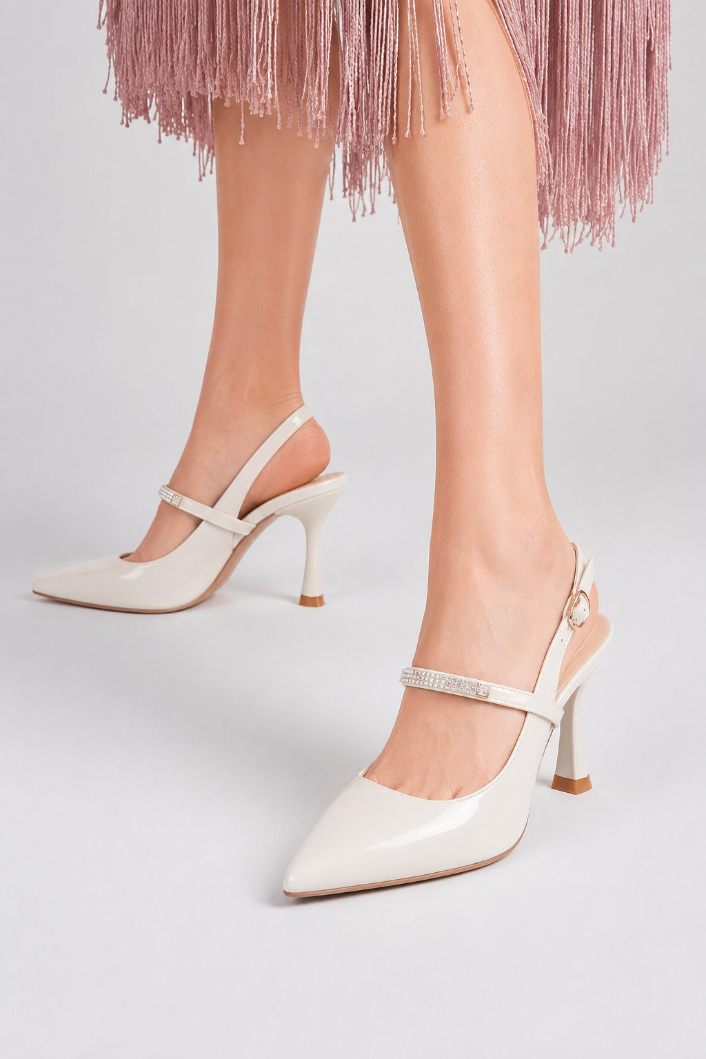 Moncelia ivory crystal strap slingback pumps, front view on model standing, women's sizes 4.5 to 9.5