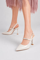 Moncelia ivory crystal strap slingback pumps, front view on model standing, women's sizes 4.5 to 9.5
