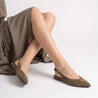 Moncelia brown pointed toe slingback ballet flats, worn seated, legs crossed, women's sizes 5 to 9.5