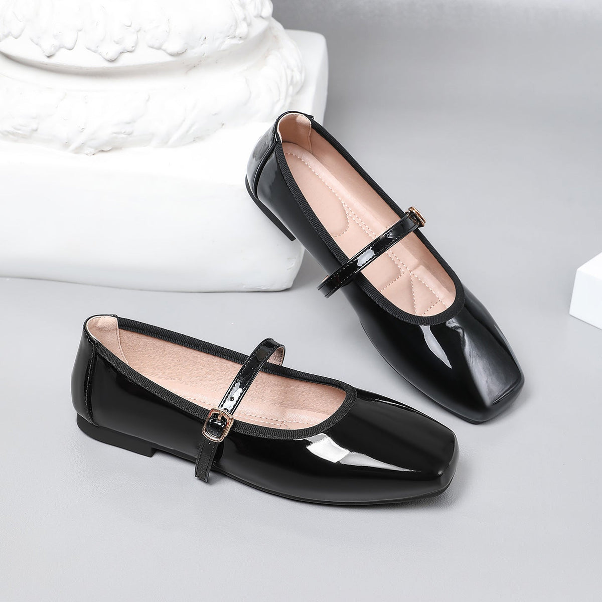 Moncelia black patent square toe Mary Jane flats, pair shown from the side, women's sizes 5 to 12