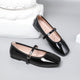 Moncelia black patent square toe Mary Jane flats, pair shown from the side, women's sizes 5 to 12