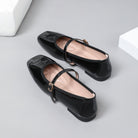 Moncelia black patent square toe Mary Jane flats, close-up of the buckled strap, women's sizes 5 to 12