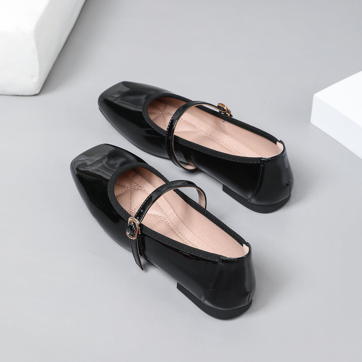 Moncelia black patent square toe Mary Jane flats, close-up of the buckled strap, women's sizes 5 to 12
