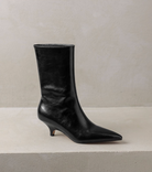 Moncelia black kitten heel ankle boots, boot in profile showing raw-edge shaft, women's sizes 5 to 11.5