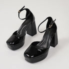 Moncelia black patent platform ankle strap heels, pair shown from above, women's sizes 5 to 10.5