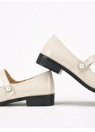 Moncelia ivory cap toe pearl button Mary Janes, close-up of the pearl button and heel, women's sizes 5 to 12