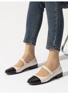 Moncelia ivory cap toe pearl button Mary Janes, front view on model with jeans, women's sizes 5 to 12