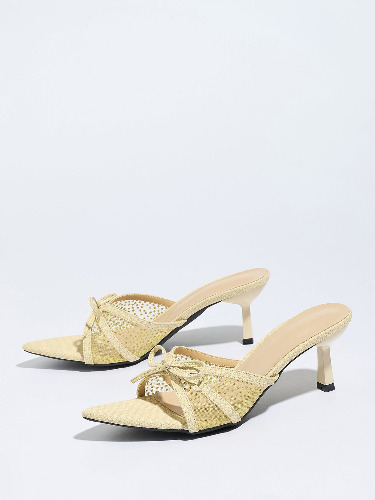 Moncelia apricot bow mesh pointed toe heeled mules, pair shown from the side, women's sizes 5 to 12