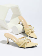 Moncelia apricot bow mesh pointed toe heeled mules, pair styled on a white display, women's sizes 5 to 12
