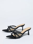 Moncelia black bow mesh pointed toe heeled mules, pair shown from the side, women's sizes 5 to 12