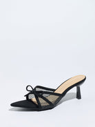 Moncelia black bow mesh pointed toe heeled mules, single shoe in profile with bow, women's sizes 5 to 12