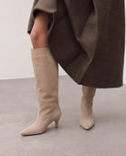 Moncelia beige pointed toe slim heel knee-high boots, worn with a brown check coat, women's sizes 5 to 12