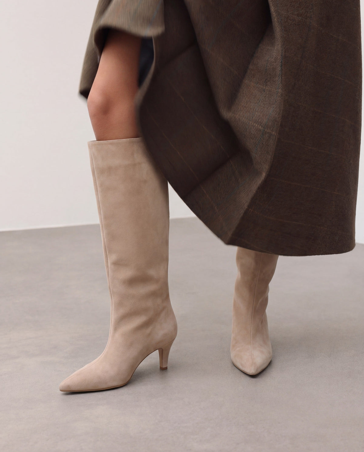 Moncelia beige pointed toe slim heel knee-high boots, worn with a brown check coat, women's sizes 5 to 12