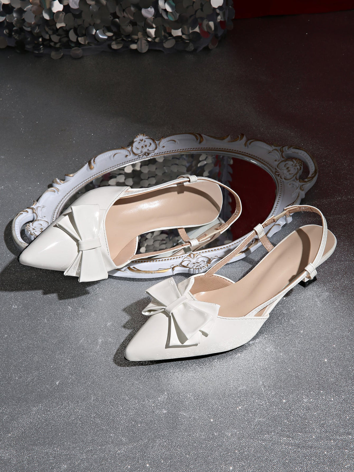 Moncelia ivory bow slingback kitten heels, pair shown from above showing pointed toe, women's sizes 5 to 11.5