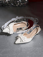 Moncelia ivory bow slingback kitten heels, pair shown from above showing pointed toe, women's sizes 5 to 11.5