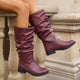 Moncelia burgundy slouchy pull-on mid-calf boots, worn on model seated on a ledge, women's sizes 5.5 to 11.5