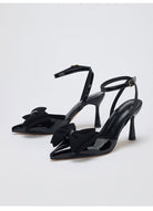 Moncelia black grosgrain bow ankle strap pumps, pair shown from the side, women's sizes 5 to 10.5