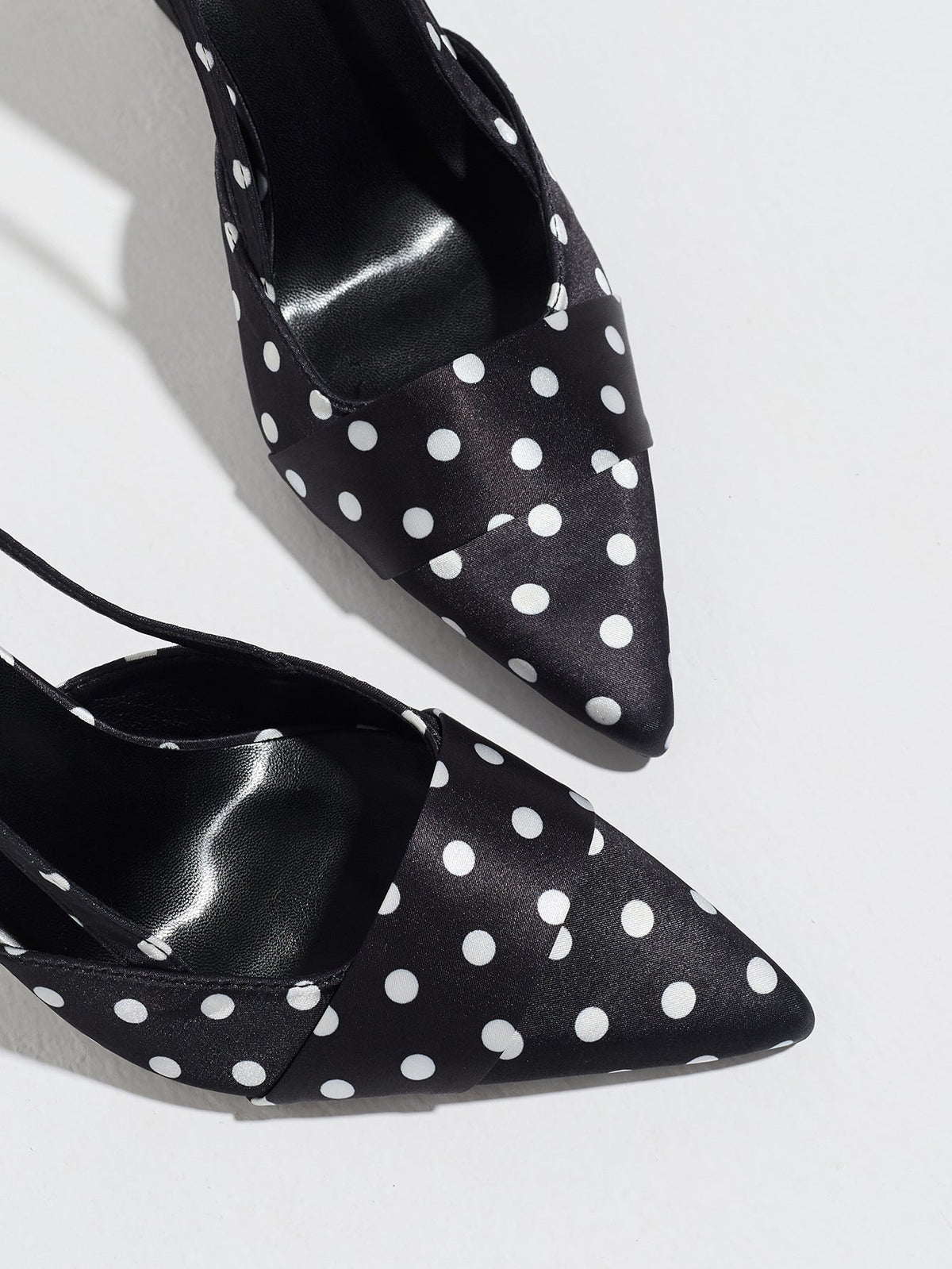 Moncelia black polka dot satin slingbacks, close-up of pointed toe and white dots, women's sizes 5 to 12