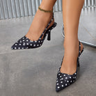 Moncelia black polka dot satin slingbacks, worn on model with ankle chain, women's sizes 5 to 12