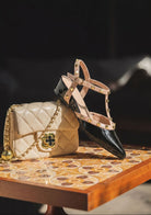 Moncelia black studded T-strap flats, patent pair styled with a quilted handbag, women's sizes 5 to 10.5