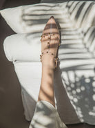 Moncelia beige studded T-strap flats, close-up of studded strap on the foot, women's sizes 5 to 10.5
