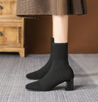 Moncelia black knit sock ankle boots, front view on model, square toe in focus, women's sizes 5.5 to 12