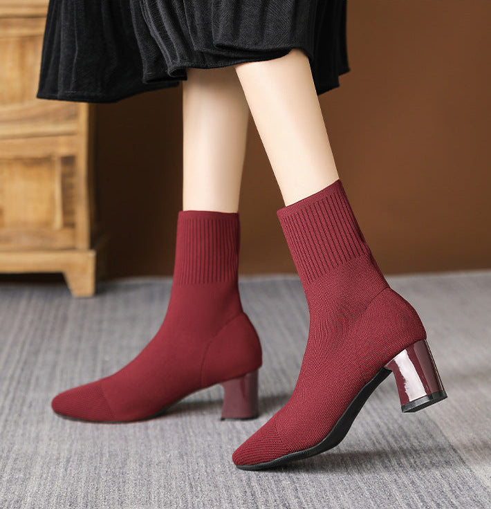 Moncelia burgundy knit sock ankle boots, front view on model with a pleated skirt, women's sizes 5.5 to 12