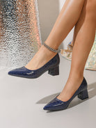 Moncelia navy croc-embossed block heel pumps, pointed toe and block heel on model, women's sizes 5.5 to 12