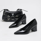 Moncelia black high-shine block heel pumps, pair shown with a studded black handbag, women's sizes 5 to 11.5