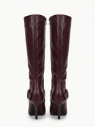 Moncelia burgundy buckled knee-high boots, back view showing inner zip and heel, women's sizes 5 to 11.5