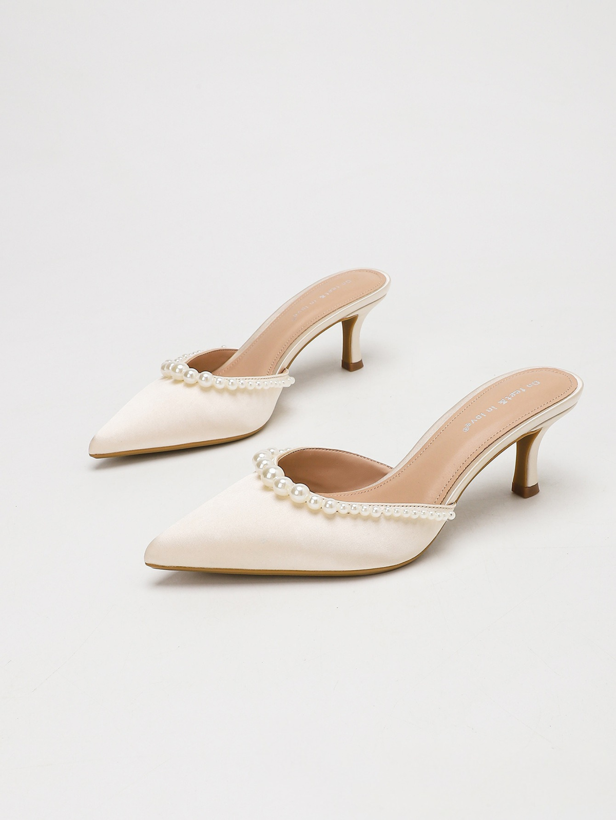 Moncelia apricot pearl trim satin mules, pair shown from the side, women's sizes 5 to 11.5