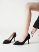 Moncelia black folded plate pointed toe pumps, worn slipping on one shoe, women's sizes 5.5 to 10.5