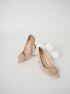 Moncelia beige folded plate pointed toe pumps, pair shown from the side, women's sizes 5.5 to 10.5