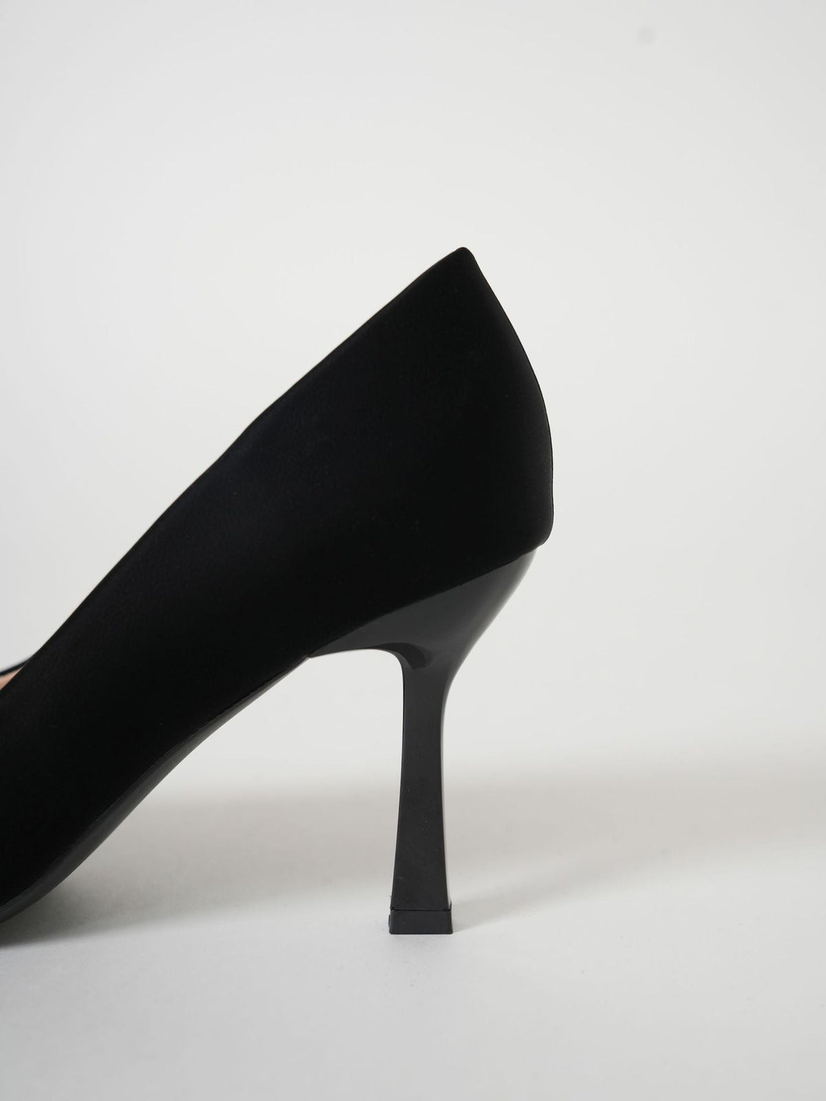 Moncelia black folded plate pointed toe pumps, close-up of the slim stiletto heel, women's sizes 5.5 to 10.5