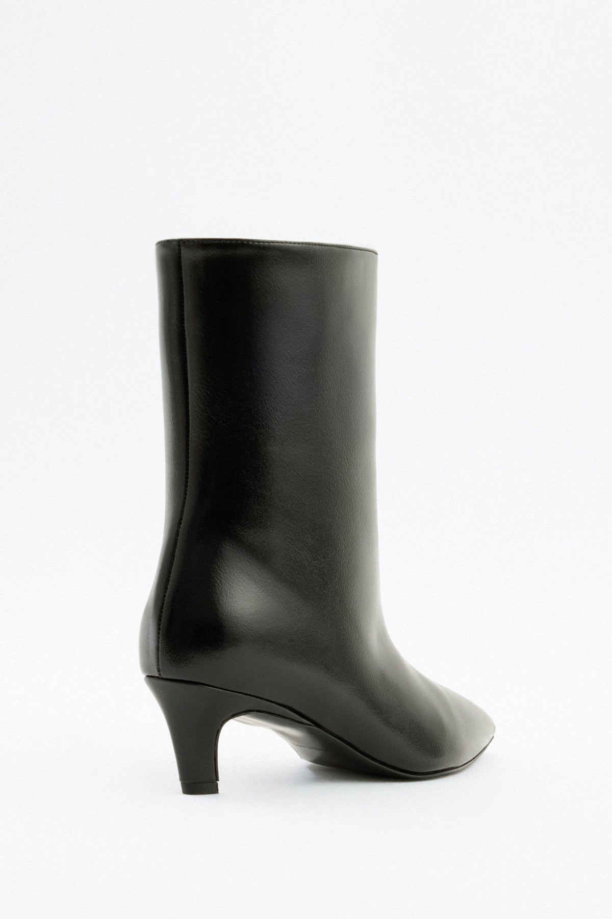 Moncelia black pointed toe kitten heel booties, back view showing curved kitten heel, women's sizes 5 to 12
