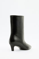 Moncelia black pointed toe kitten heel booties, back view showing curved kitten heel, women's sizes 5 to 12