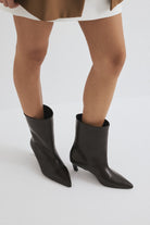 Moncelia brown pointed toe kitten heel booties, front view on model, women's sizes 5 to 12