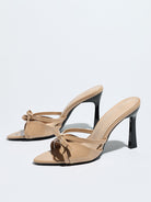 Moncelia apricot bow pointed toe heeled mules, patent pair shown from the side, women's sizes 5 to 12