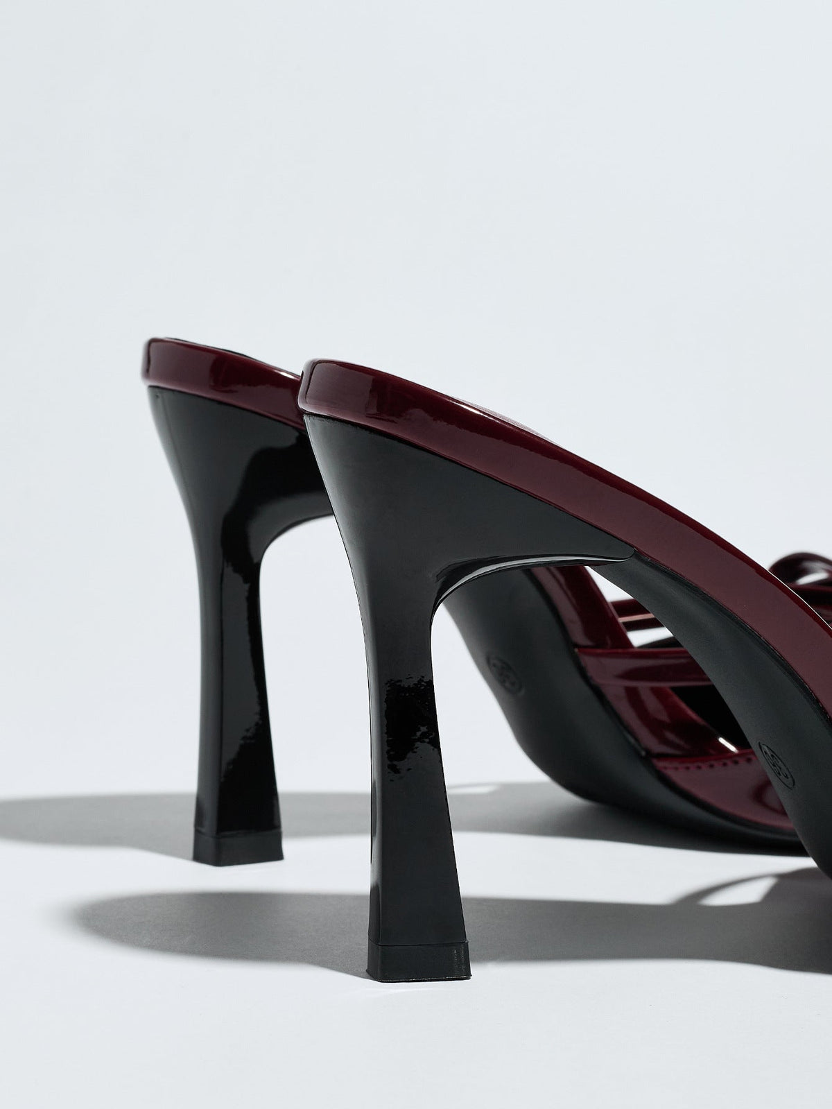 Moncelia burgundy bow pointed toe heeled mules, back view showing flared black heels, women's sizes 5 to 12