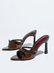 Moncelia brown bow pointed toe heeled mules, patent pair shown from the side, women's sizes 5 to 12